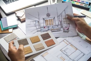 point of view of looking at flooring samples and a hand drawn picture of a living room layout