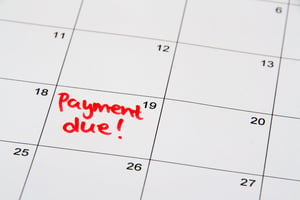 close up view of a calendar with no appointments other than the words payment due on the 19th