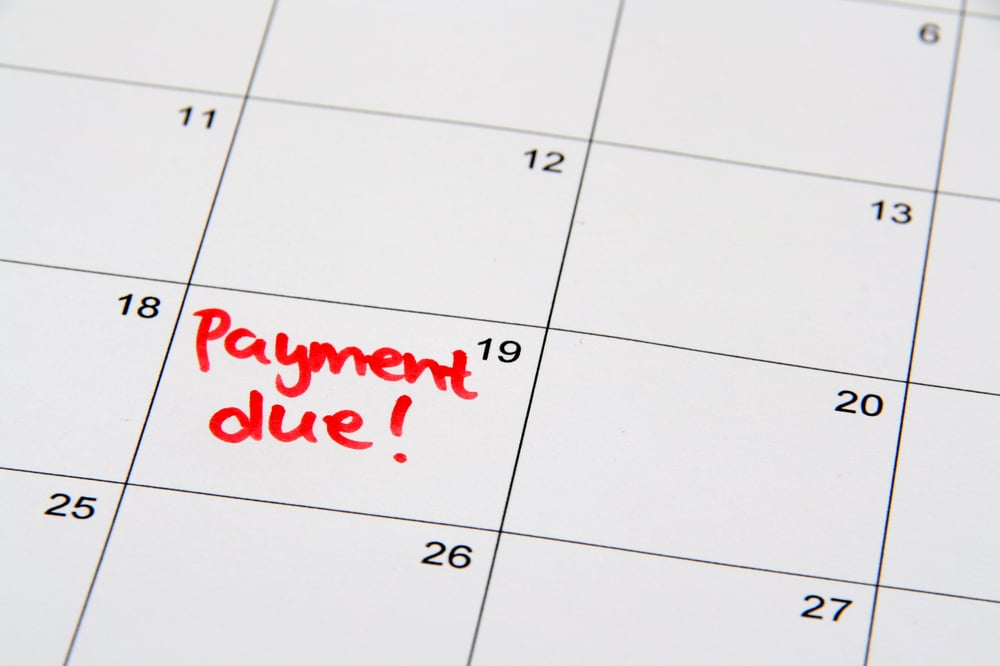 close up view of a calendar with no appointments other than the words payment due on the 19th