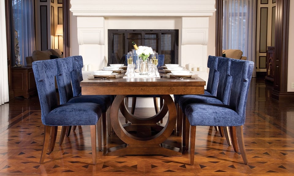 dining room with a fireplace, solid wood table and seven surrounding upholstered chairs