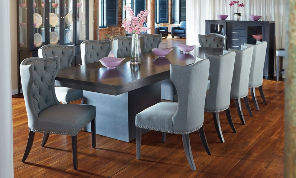 dining room with large solid wood table and eight surrounding upholstered chairs with a china cabinet and a hutch within the room