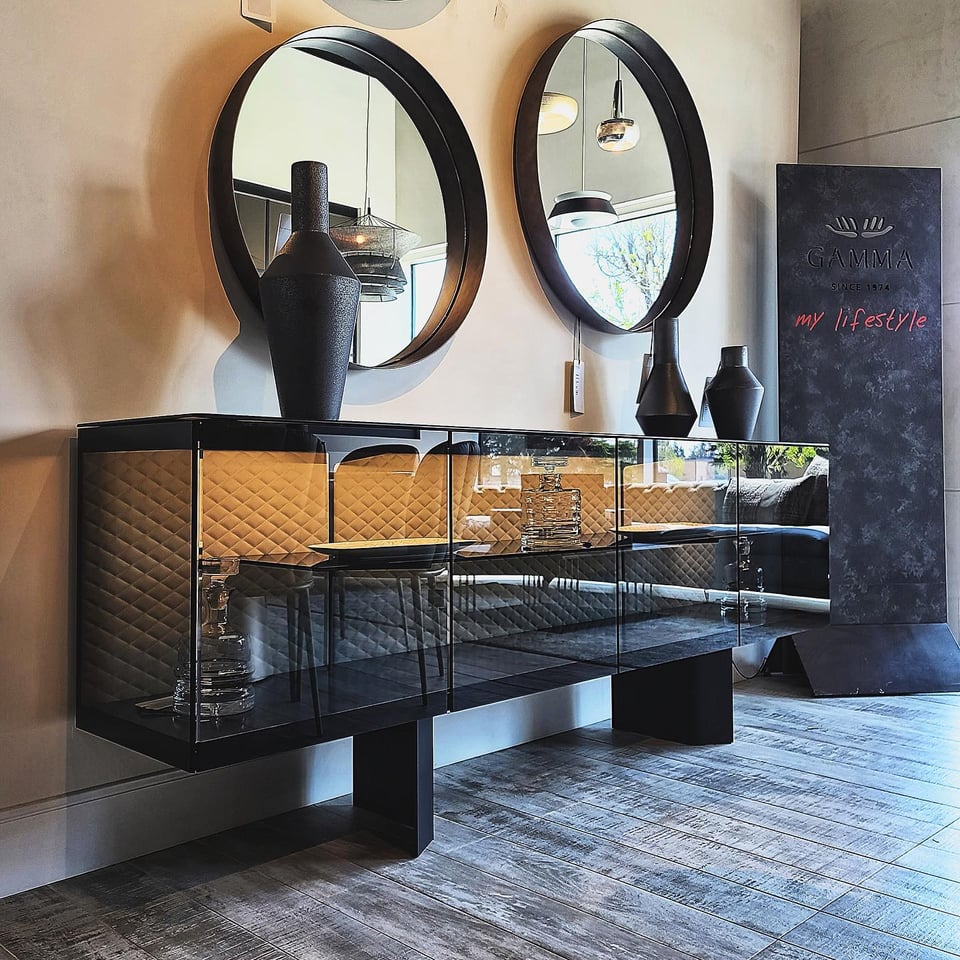 interior of Finesse furniture store with glass console and three vases on top and two accent mirrors