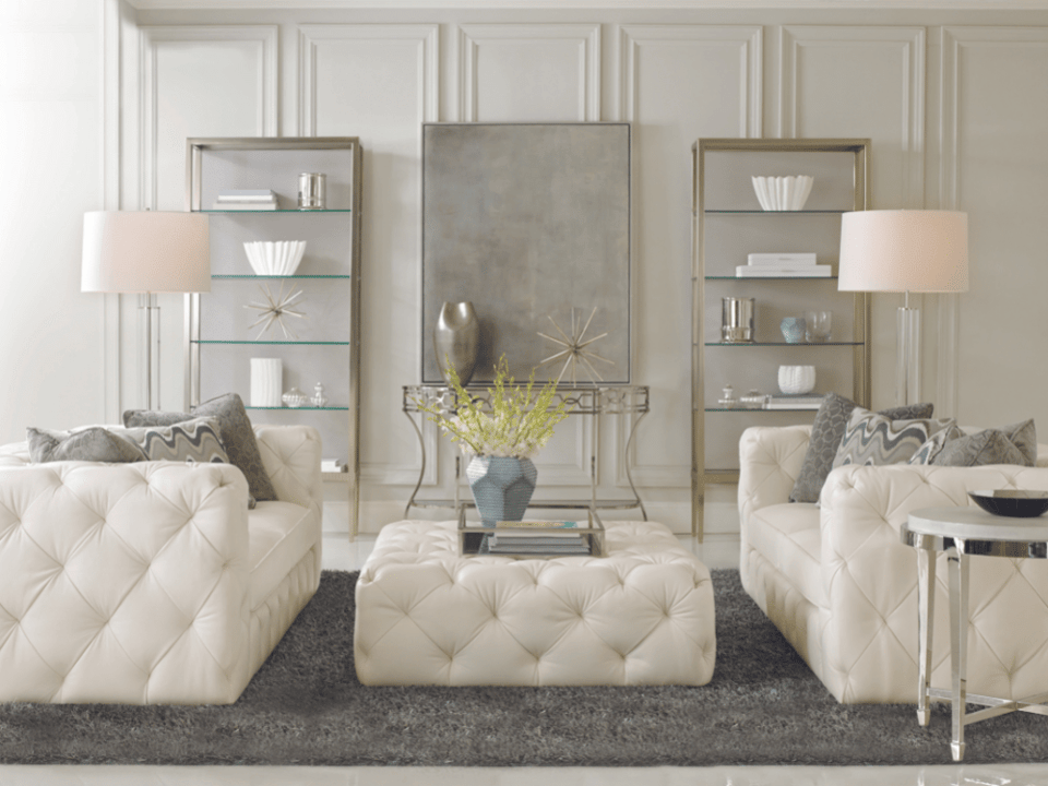 two tufted leather sofas on either side of a tufted leather ottoman over a shag area rug