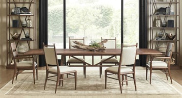 dining room setting with wooden table and four upholstered chairs over and area rug
