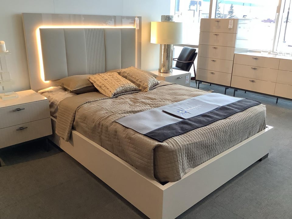 interior of Scandia furniture store showing a bed frame with lights and bedroom set of dresser and nightstands
