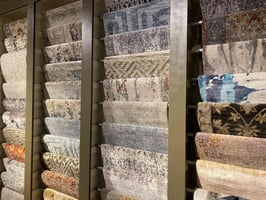 feature wall of various samples of area rugs