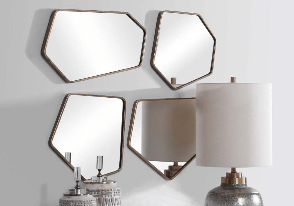 four uniquely shaped mirrors grouped  above decorative vases and a lamp