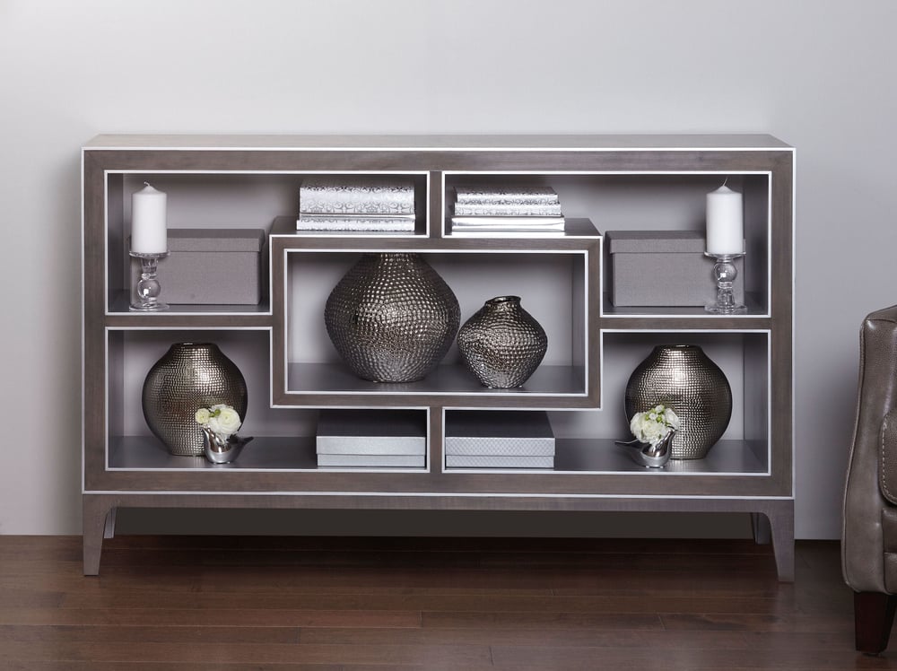 decorative wood console table with five shelves holding accent pieces