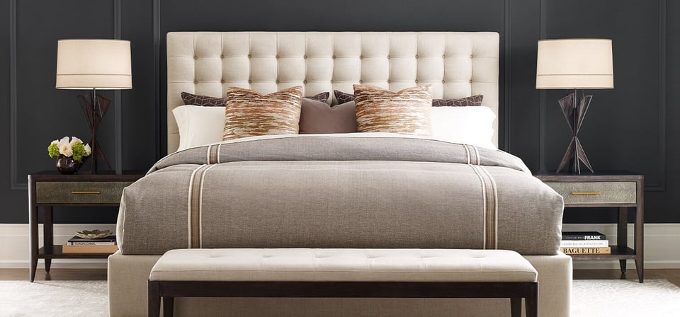 bedroom suite with tufted headboard and bench, two matching night stands with accompanying lamps