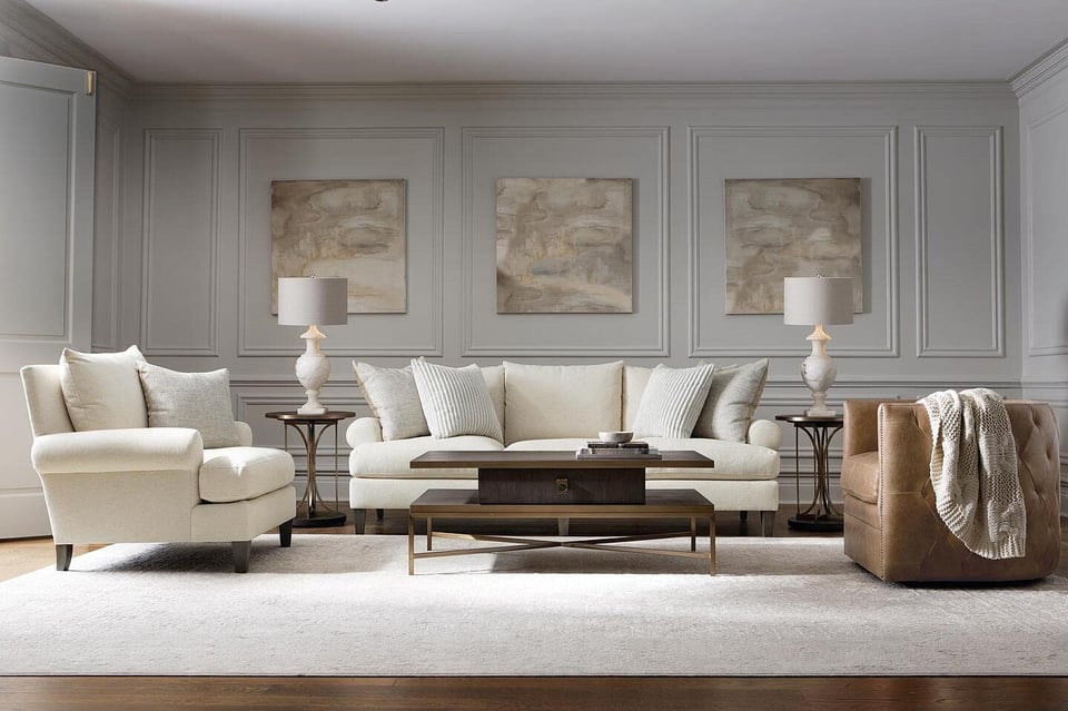 sofa with two accent chairs facing rectangular coffee table over area rug