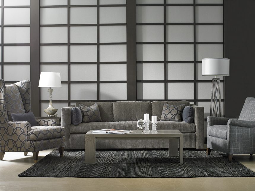 living room with sofa and two accent chairs and wooden coffee table