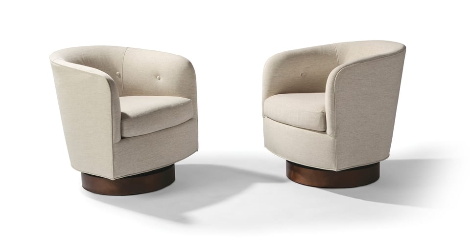 two matching low-profile upholstered swivel chairs facing each other