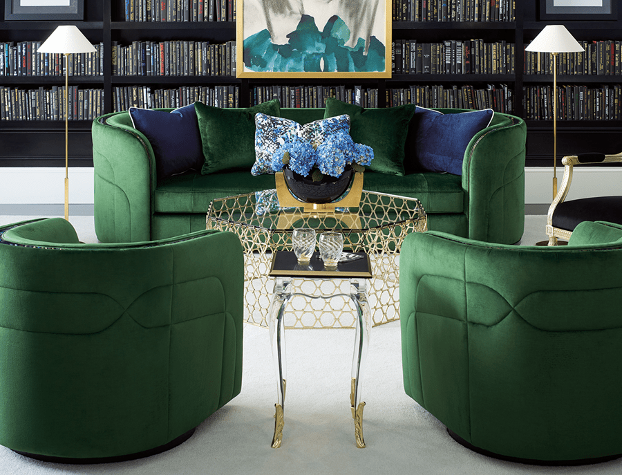 living room setting with sofa and three accent chairs around a glass coffee table with flowers on top