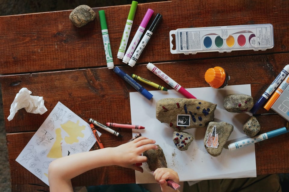child uses coffee table to make messy art