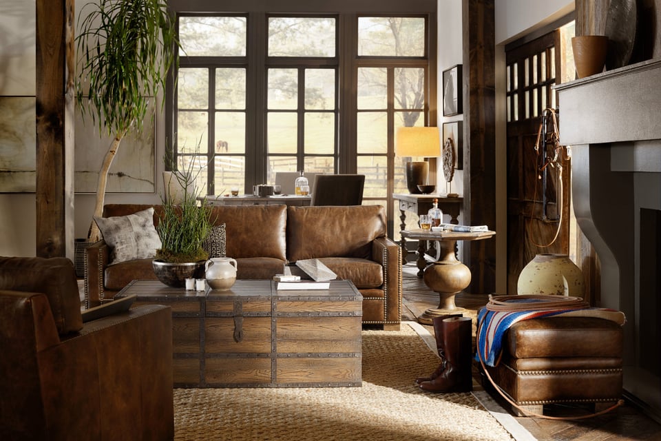 trunk coffee table surrounded by rustic leather sofa and accent furniture