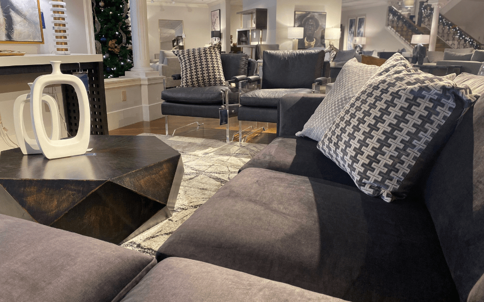 living room with fabric sectional and two matching leather chairs around a wooden coffee table