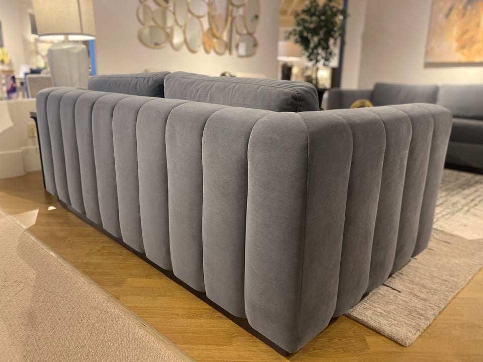 detailed back of a fabric sofa in a living room with another sofa