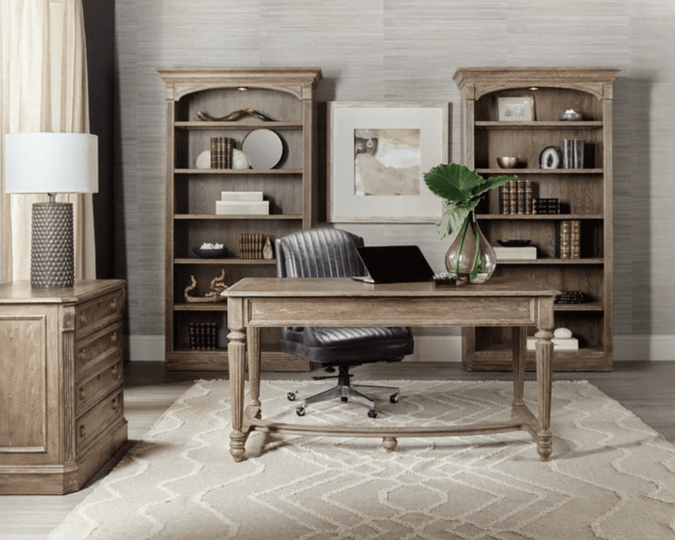 Home office with writing desk, leather rolling office chair, dresser and two matching bookshelves