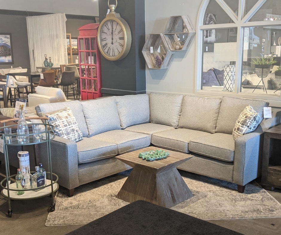 interior of Reside furniture store showing a sectional around a coffee table and drink cart