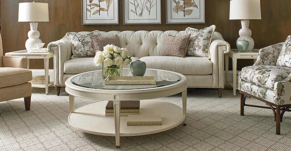 two seater sofa behind circular coffee table with decoration