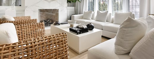 pillow back sofa with shallow seat in living room with wicker chairs and boxy coffee table