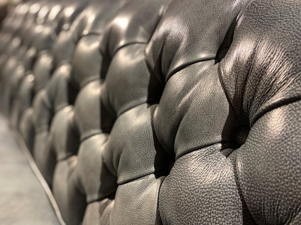 close up of a tufted leather sofa