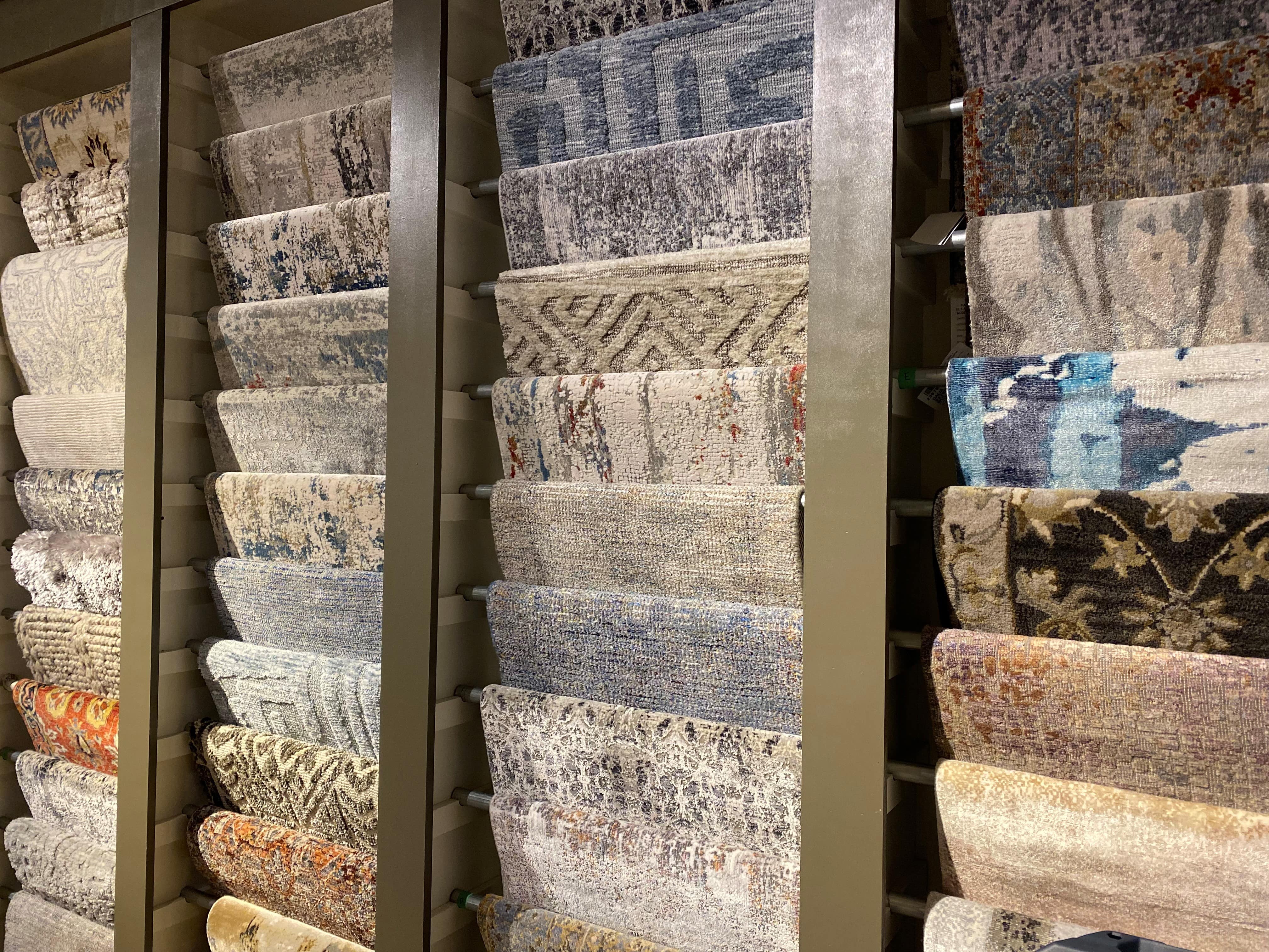 feature wall of various samples of area rugs