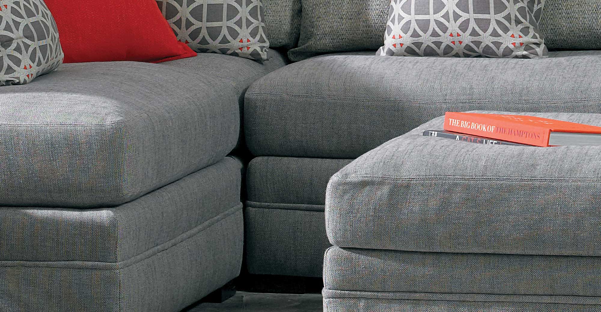 close up of the cushions and seating of a sectional and matching ottoman